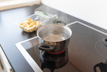 There is a pot of boiling water on the stove