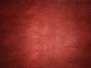 Red suede vignette edge dark and light in the center of the frame.