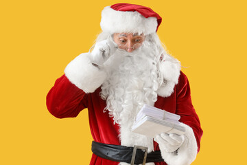 Shocked Santa Claus with letters on yellow background