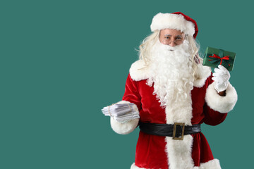 Santa Claus with letters and Christmas gift on green background