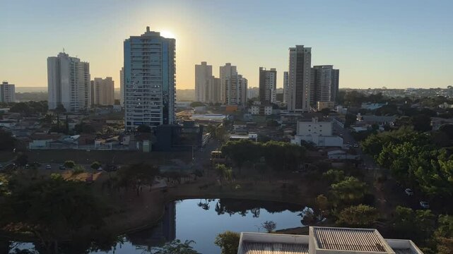 Panoramic view of the building landscape around Parque Ipiranga Square in An&aacute;polis, Goi&aacute;s, Brazil. The footage captures urban architecture surrounded by trees and a calm atmosphere. Time-lapse video.