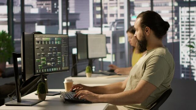 Developer working with artificial intelligence machine learning tech, improving company systems. IT expert in office focused on transforming data into predictive models, camera A
