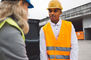 Construction industry and engineering - engineers, architects and contractors on the construction site analyzing the development of the building