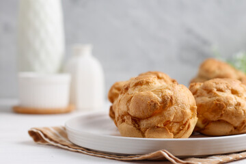 Choux pastry on a white plate. perfect for recipe, article, or any commercial purposes.