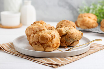 Choux pastry on a white plate. perfect for recipe, article, or any commercial purposes.