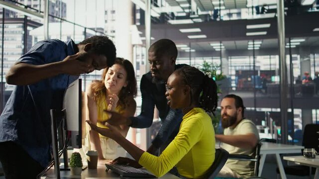 Upset IT workers in office debating, doing brainstorming, looking through lines of code on computer. Team of company employees discussing in workspace, disagreeing with each other, camera B