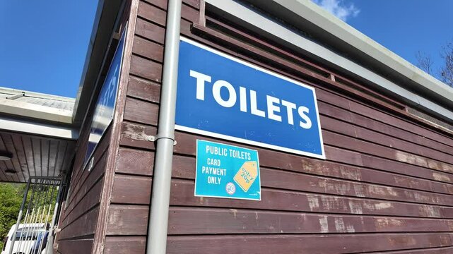 Looe Cornwall England.  30.09.2024. Video.  Sign for public toilet  entrance twenty pence to be paid by card.