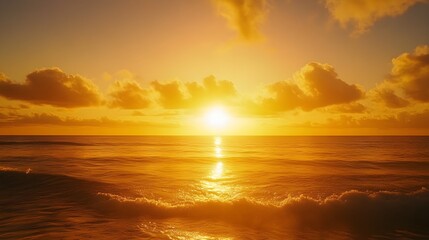 Obraz premium A peaceful golden sunset spreading warm hues across the sky and ocean, with gentle waves glistening in the fading light, evoking a sense of calm and awe 