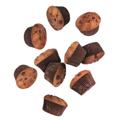 Delicious chocolate muffins in air on white background