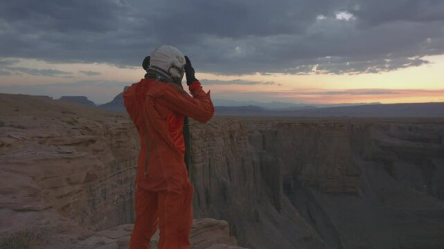 Exploring the majestic desert crater at sunset in astronaut gear