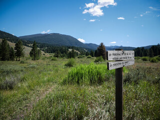 Wooden trail sign in recreation area in Madison Mountain Range in Gallatin National Forest near Big Sky Montana 