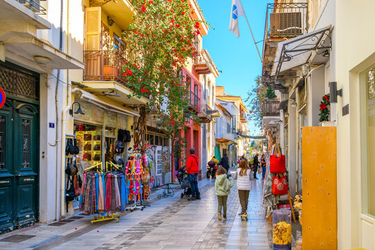 Fototapeta A colorful narrow street of shops, boutiques and cafes in the picturesque old town of Nafplio, Greece, a seaside town in the Southern Peloponnese district.