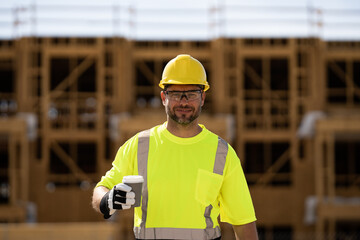 Civil Worker engineer african american man wearing hard hat and smiling. happy positive manager or contractor, heavy machinery. Construction worker on top of a building. builder in working uniform