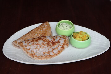 Ragi Set Dosa, Songy soft pancake, , dosa made with fermented batter of finger millet, rice and lentils, south Indian food served with coconut chutney and pototo curry (aloo masala)
