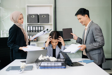 Furious Asian businesspeople arguing strongly after making a mistake at work in office