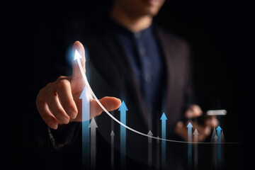 investment and finance concept, businessman holding virtual trading graph and blurred light on...