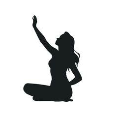 A silhouette of a woman sitting with her arms raised at sunset against a city skyline background