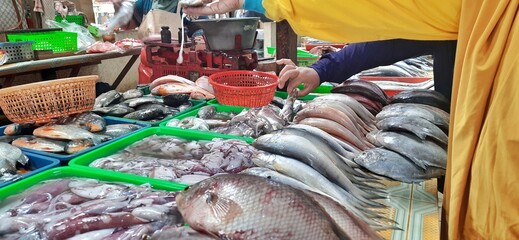 The atmosphere at the traditional market in Indonesia. Seller and buyer transaction. Various...