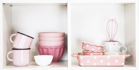 Shelves in wooden rack with pink and green dishes close up