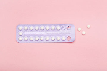 Oral contraceptive pills on pink background