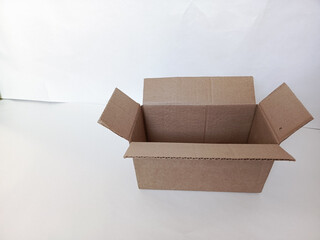Cardboard box on a white background close-up. Cardboard box stands on the table for packing goods. Moving, sending a parcel. Background, space for text. Delivery.