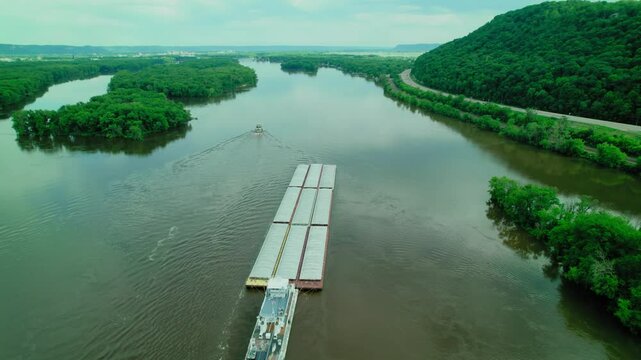 Tugboat pushing barge scow on Mississippi River in Wisconsin