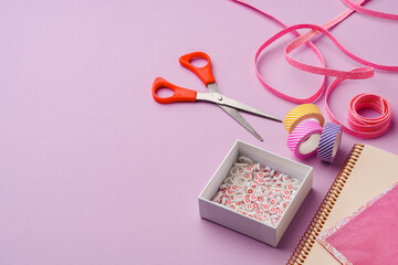 Crafting supplies on a purple background ready for creative projects