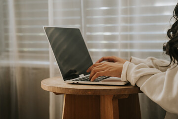 Cozy Workspace: Woman working on laptop at home  