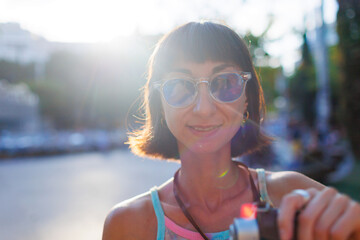 woman photographer with a camera takes pictures outdoors. A young female photographer aims the lens...