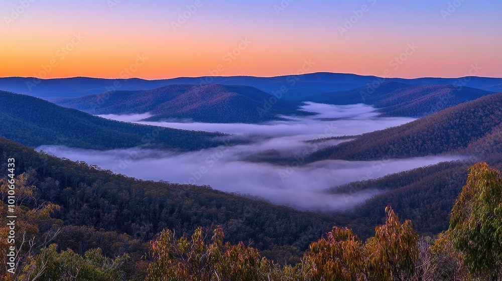 Aufkleber a panoramic view of a mountain range at dawn with layers of mist rolling over the peaks and valleys 
