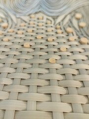 Fototapeta premium A meticulously woven pattern, likely made from light-colored materials
