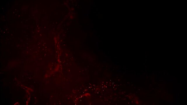 Swirling red blood or other fluid moving and spreading slowly on black background