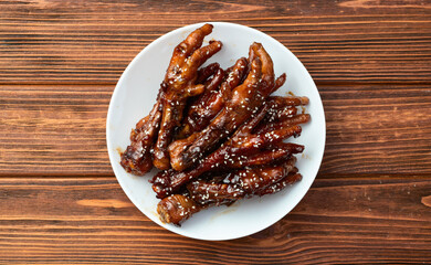 Caramelized korean or Chinese chicken foots ( paws ) with sesame . Top view
