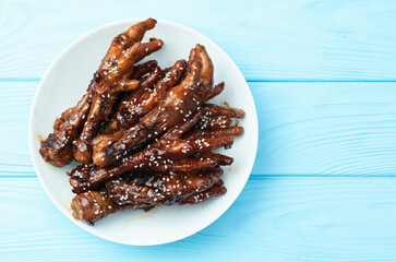 Caramelized korean or Chinese chicken foots ( paws ) with sesame . Top view