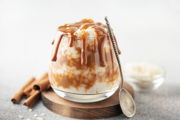 Homemade Spanish Arroz con Leche or South American Dulce de Leche Rice Pudding in glass on the table
