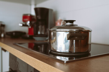 saucepan on glass hob in kitchen