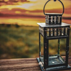 Lantern on the background of the sunset. Vintage style.