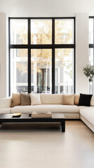 Fototapeta premium Modern living room with large windows showcasing autumn foliage during the day