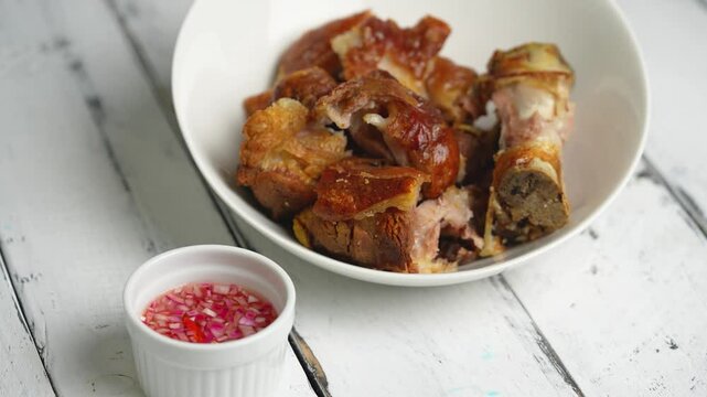crispy pata or deep fried pork leg with a sweet white vinaigrette sauce, it is a well known food in the Philippines 