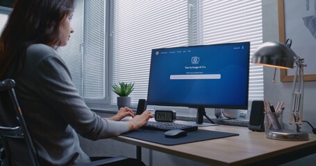 Adult woman types prompt in artificial intelligence chatbot on PC. Advanced AI image generator generate detailed high-quality photo portrait of sci-fi robot. AI generated image creation technology.