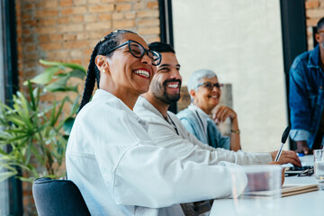 Confident team members collaborating during a meeting, showcasing positive teamwork and engagement...