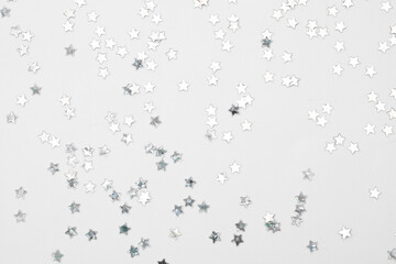 sparkles silver stars on white background with text place- Image