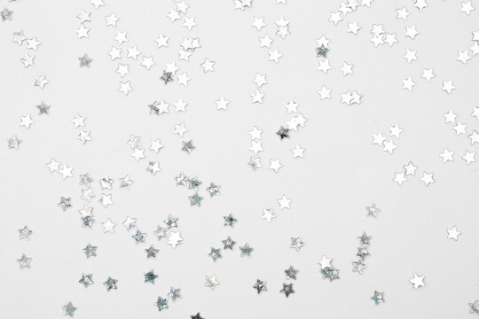 sparkles silver stars on white background with text place- Image