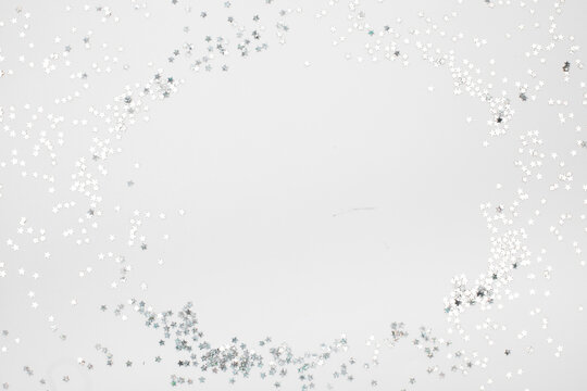 sparkles silver stars on white background with text place- Image