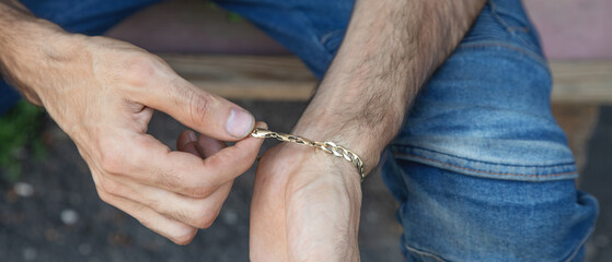 Male hand with a expensive bracelet. Fashion accessories and jewelry