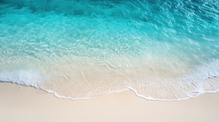 Obraz premium Sandy beach with soft ripples of sand in the foreground, leading to a clear turquoise sea under a bright summer sky. Perfect for a relaxing coastal vibe.