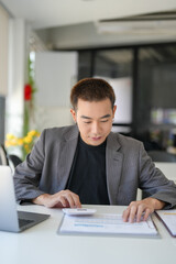 Obraz premium Confident asian business man Auditor or internal revenue service staff checking annual financial statements company Audit &nbsp;Accounting tax.
