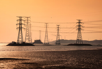 Power cables of transmission towers on the sea with the background of Yeongheung Thermal Power Plant at Yeongheungdo Island near Ongjin-gun, Incheon, Korea