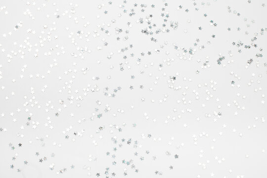 sparkles silver stars on white background with text place- Image