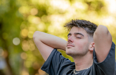 relaxed young man breathing outdoors